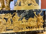 a clock that has a statue on top of it