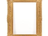 a gold frame with a white background and a white wall