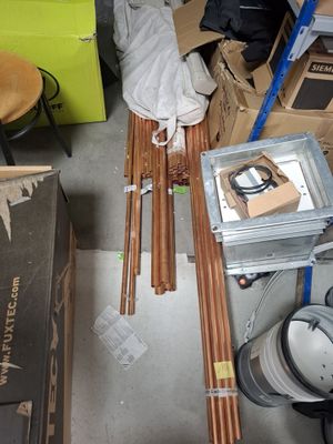 a pile of skis sitting on the floor in a room
