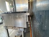 an image of a kitchen area with a sink and a hose