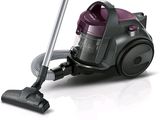un aspirateur posé par terre à côté d'un cordon d'alimentation