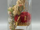 a glass clochet with a red chair under a glass dome