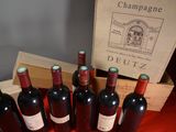 several bottles of wine are lined up in a row on a table