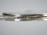 a close up view of a pair of silver bracelets