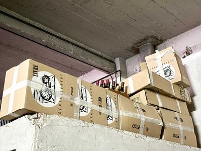many boxes stacked on top of each other on a shelf