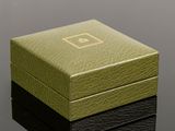 an image of a green and black box on a black surface