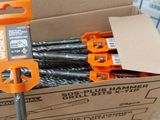 a bunch of drill bits in a box on the floor