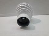 a white vase sitting on a table with a white wall in the background