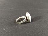 a close up of a silver ring on a black surface
