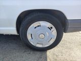 a white van that has a flat tire on the side of the road