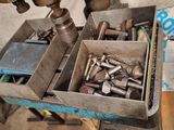 a box of screws and nuts on a workbench