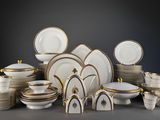 many different types of plates and bowls on the table