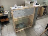 a desk that has a glass top and a metal shelf