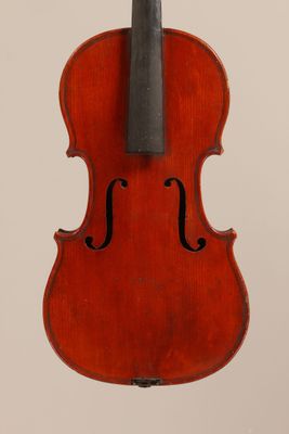an old violin with a bow hanging from it ' s back
