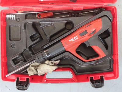 a red tool case with tools in it on a table