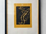 a framed picture of a black and gold painting on a white wall