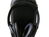 a pair of black headphones sitting on top of a case
