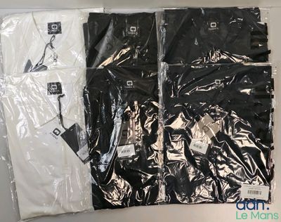 two pairs of black and white shirts sitting on top of each other