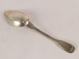 a silver spoon with a spoon handle on a white surface