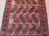 an antique persian rug with a red and blue design