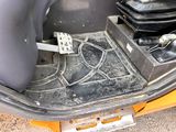 a close up view of a car ' s trunk with a foot rest