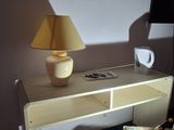 a small desk with a lamp on top of it