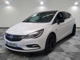 a white opel is parked in a room with a checkered floor