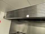 a stainless steel exhaust hood in a commercial kitchen