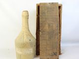 a bottle of wine next to a box on a table