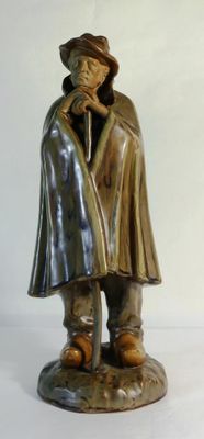 a statue of a man with a hat and a cane