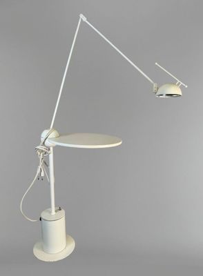 an image of a white table with a lamp on top of it
