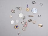 many different types of silver and gold jewelry on the table