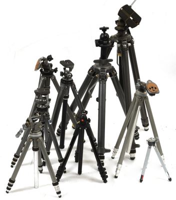 many different types of tripods sitting on a white surface