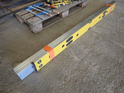a large yellow beam sitting on the floor next to a pallet