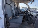 the interior of a white van with black seats and a steering wheel