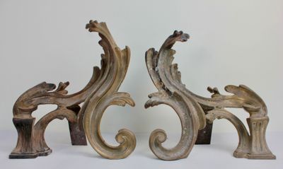 a pair of ornate wooden sculptures on a white surface