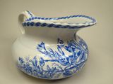 a blue and white pitcher with a blue floral design on it