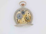a silver pocket watch on a white surface with a white background