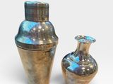 two vases sitting next to each other on a white surface