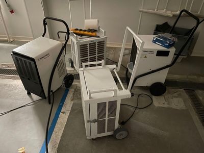 deux climatiseurs et un chariot dans une pièce