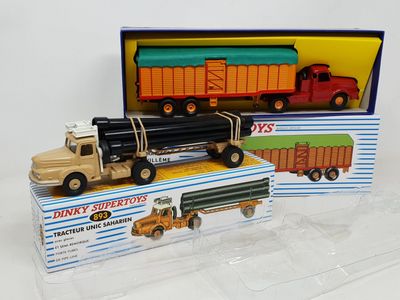 two toy trucks that are sitting in a box
