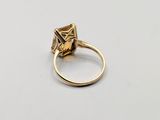 a close up of a gold ring with a stone in the middle