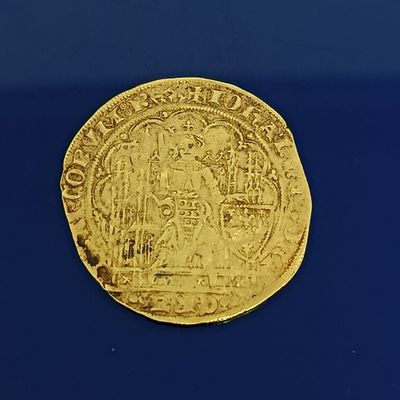 l'image d'une pièce d'or sur laquelle figure l'image d'un homme