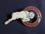a lapel pin with a picture of a ram on it