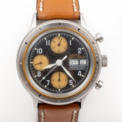 a watch that is sitting on a white surface