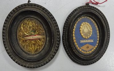 two framed pictures hanging on the wall of a room