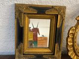 a picture of a clock and a mirror on a table