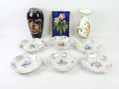 many different vases and plates that are sitting on a table