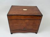 an antique wooden box with a brass button on the lid