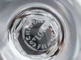 a close up view of a glass of water with a clock on it